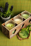 Candles in wooden candlestick, lavender and soap, on green mat