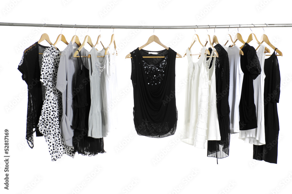 Set of fashion female clothing hanging on hangers Set of fashion female clothing hanging on hangers