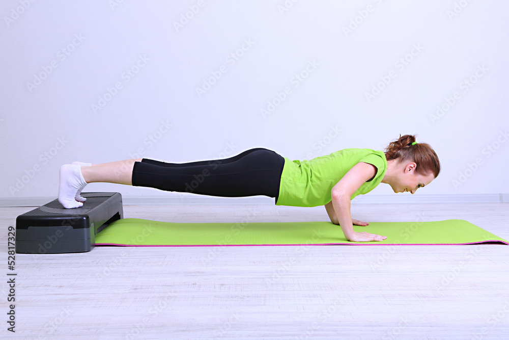 Beautiful young woman exercises on stepper Beautiful young woman exercises on stepper