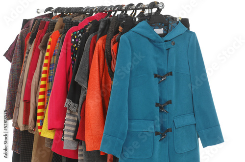 female coat clothes hanging on clothes rack