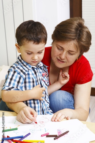 Mother teaches her son to draw