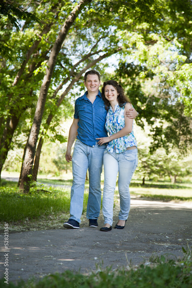 Happy middle-age couple walking in park Happy middle-age couple walking in park