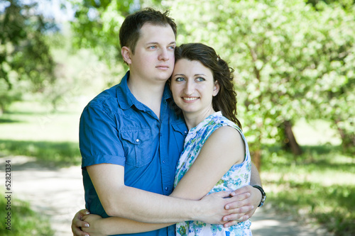 happy middle-age couple in park looking ahead
