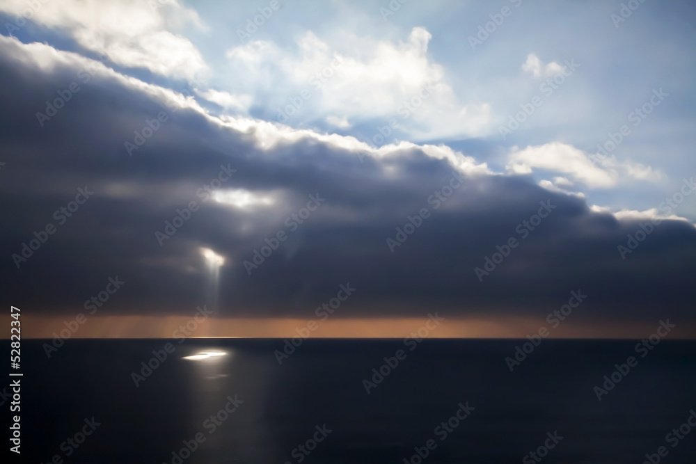 Sea Scape with Sun Beams Piercing Clouds, and Harsh Light.