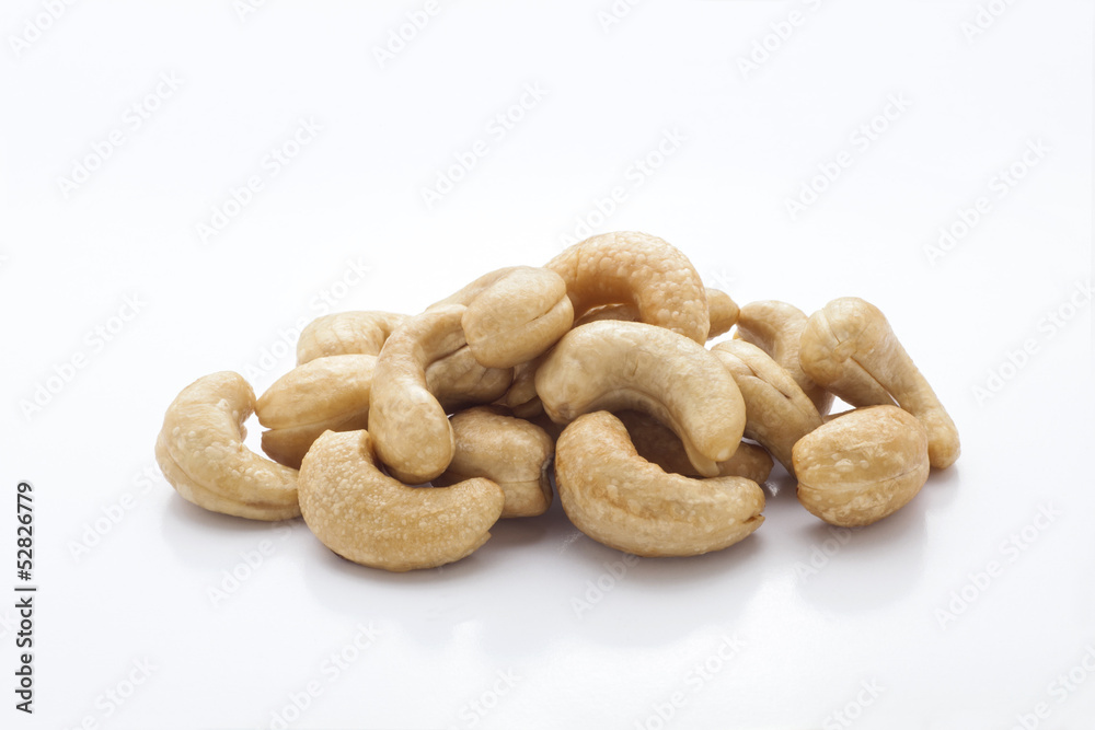pile of roasted cashew nuts in isolated white background pile of roasted cashew nuts in isolated white background