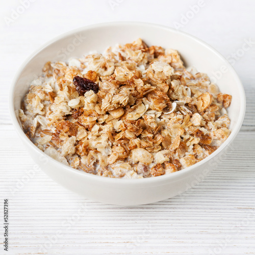 Muesli granola with raisin in wooden bowl