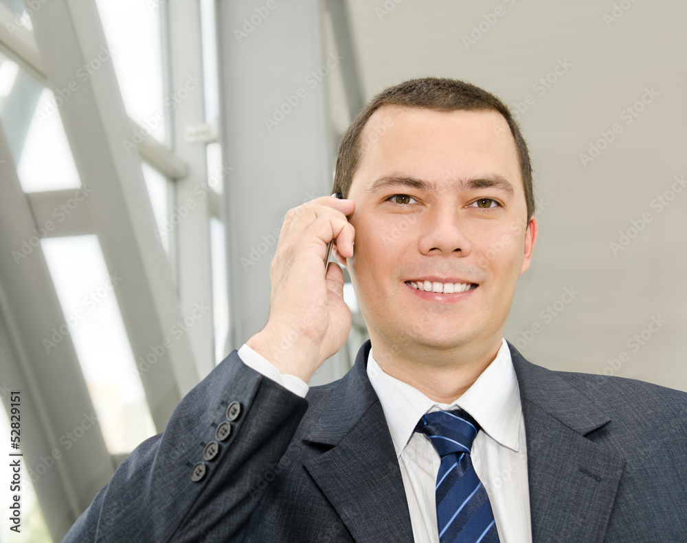 Portrait of young businessman calling by telephone Portrait of young businessman calling by telephone