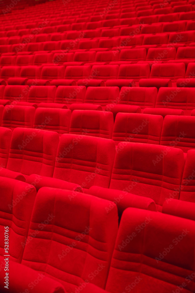 Rows of red arm-chairs in empty hall Rows of red arm-chairs in empty hall