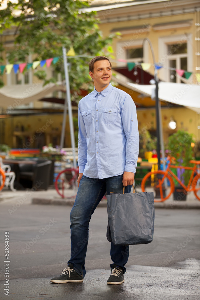 Man with shopping bags walking outdoors