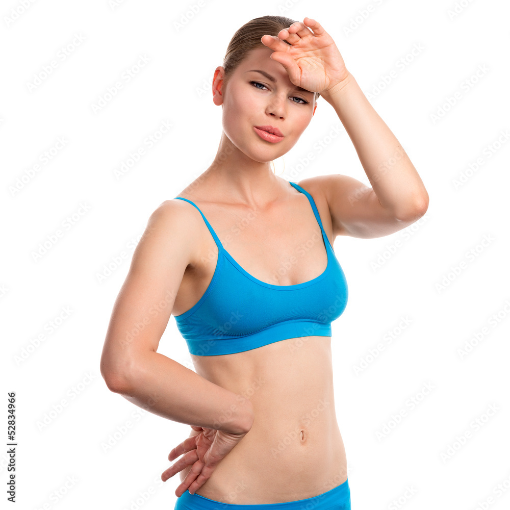 Tired young female runner touching her brow, isolated Tired young female runner touching her brow, isolated