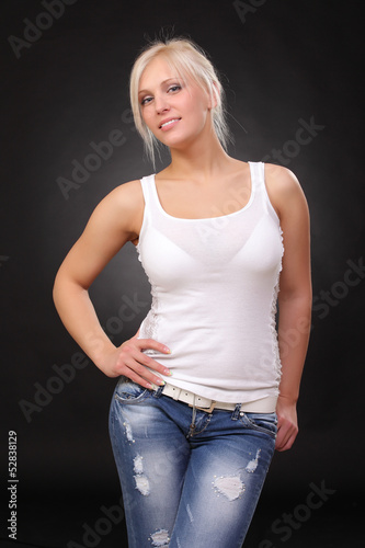 a young blonde wearing jeans and a tank top