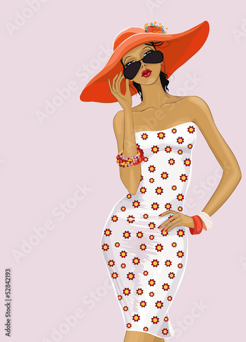 Beautiful girl in a red hat looking over sunglasses