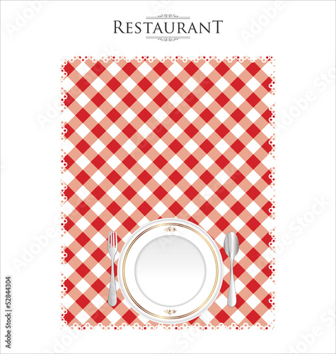 White plate on a checkered red tablecloth
