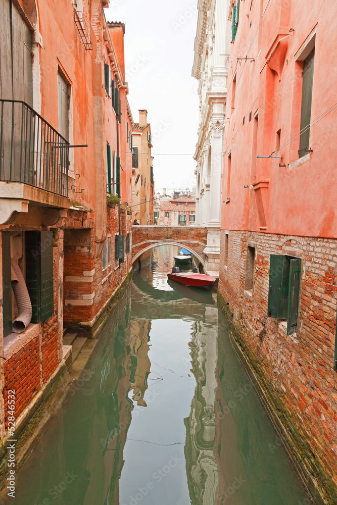 Canal with houses, bridge and boats. Venice. Italy.