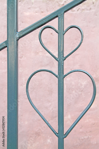 Heart shape from metal frame against pink background