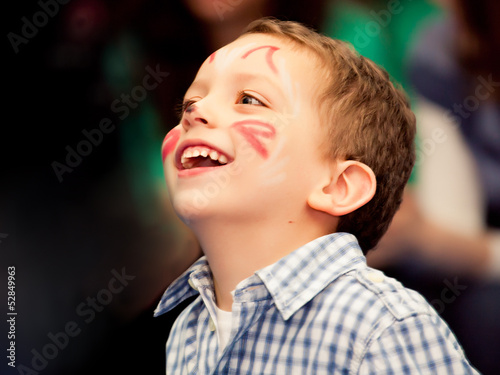 boy with painted face on the hioliday photo