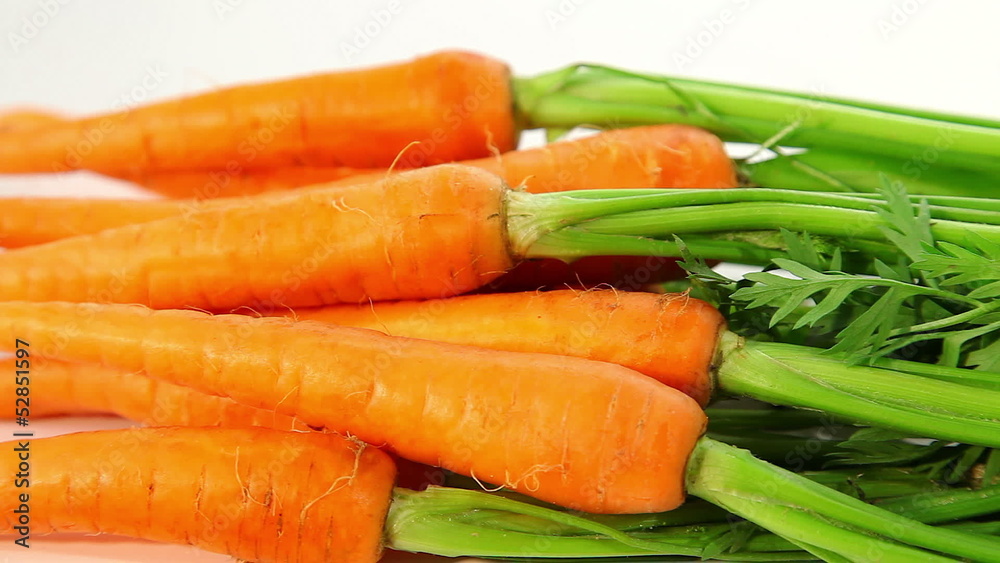 Fresh raw carrot with green haulm, dolly shot Fresh raw carrot with green haulm, dolly shot