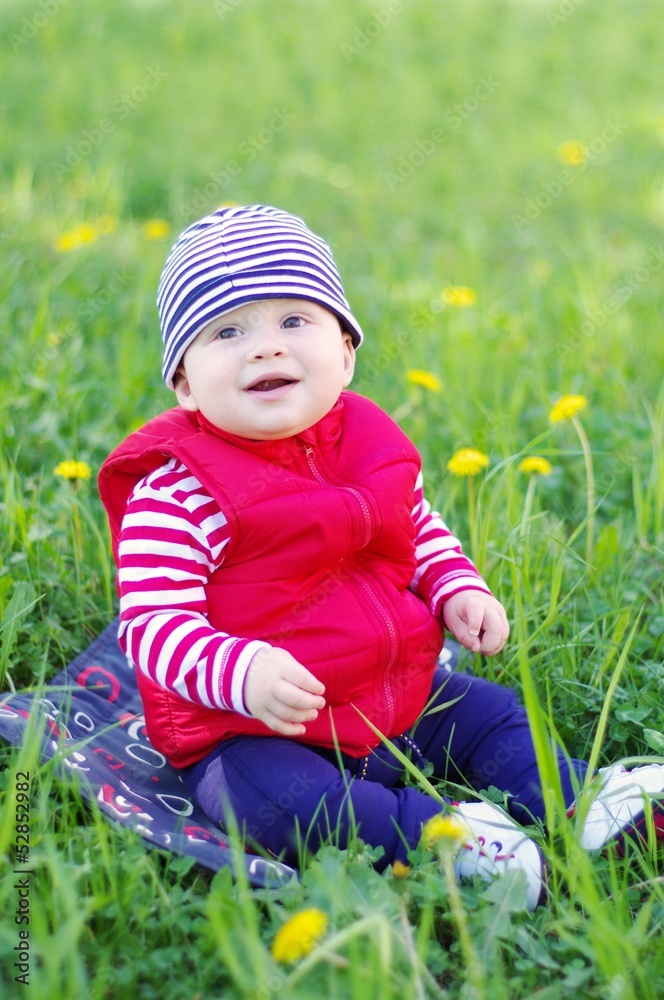 baby boy age of 8 months sitting on grass baby boy age of 8 months sitting on grass