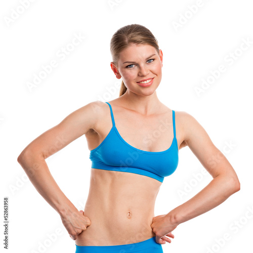 Joyful girl with sporty body looking at the camera, isolated