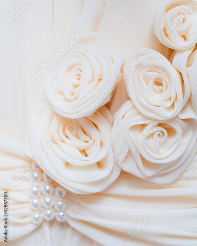 Cream fabrics roses and pearl beads on the dress