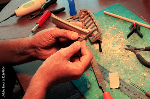 man arms making boats models