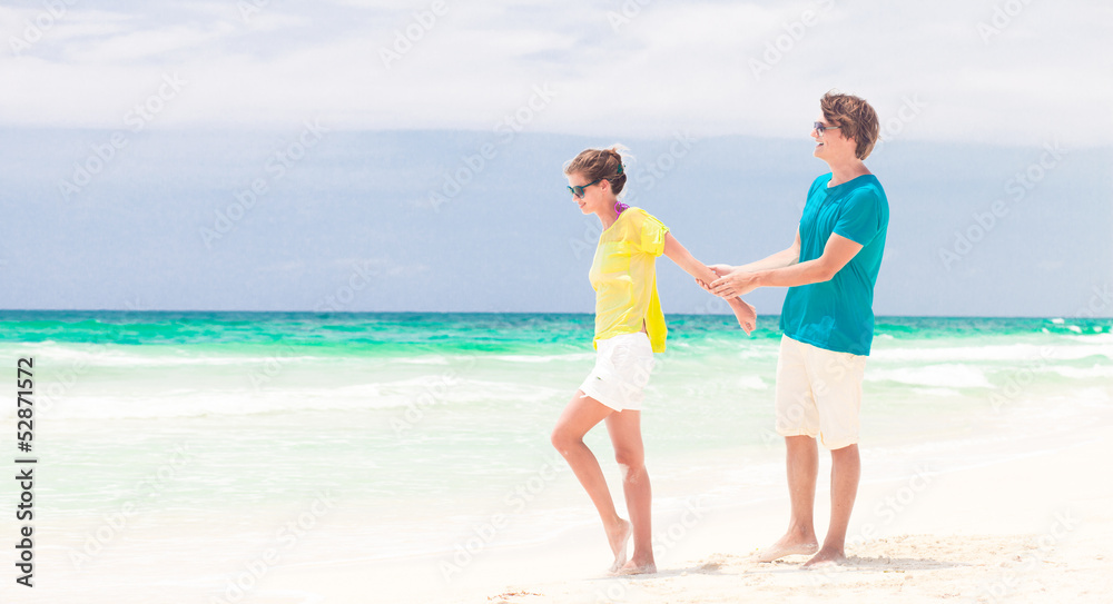 young happy couple having fun on the beach