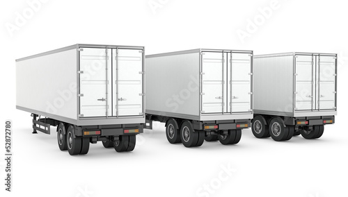 Three blank white parked semi trailers
