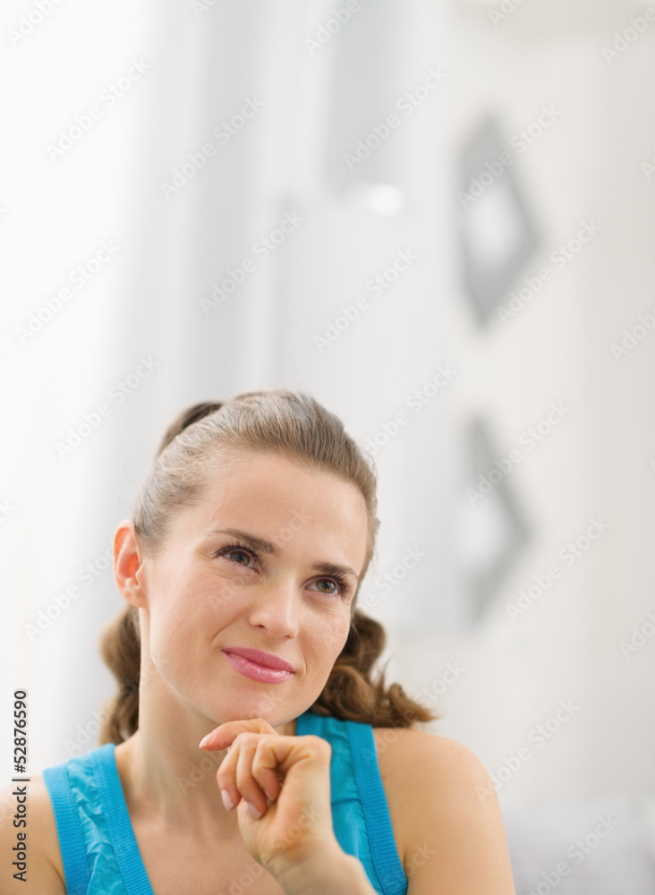 Portrait of thoughtful young woman in living room Portrait of thoughtful young woman in living room