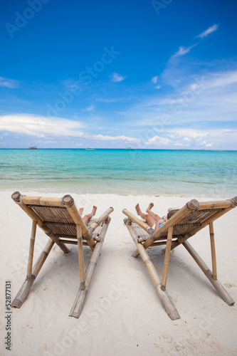 Two beach chairs on perfect tropical white sand beach in