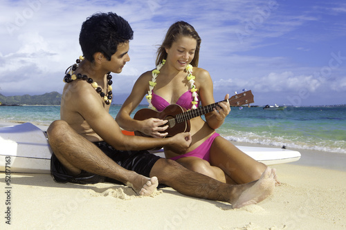 couple on beach with ukulele