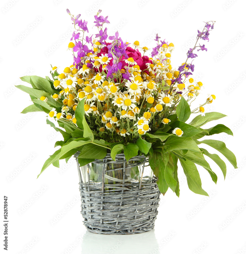 Bouquet of wild flowers in wicker vase, isolated on white