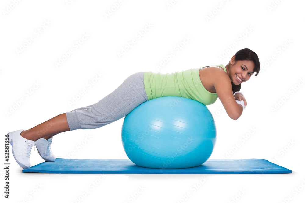 Fototapeta premium Woman Exercising On Pilates Ball