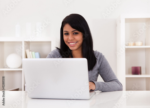 Young Woman Using Laptop © Andrey Popov