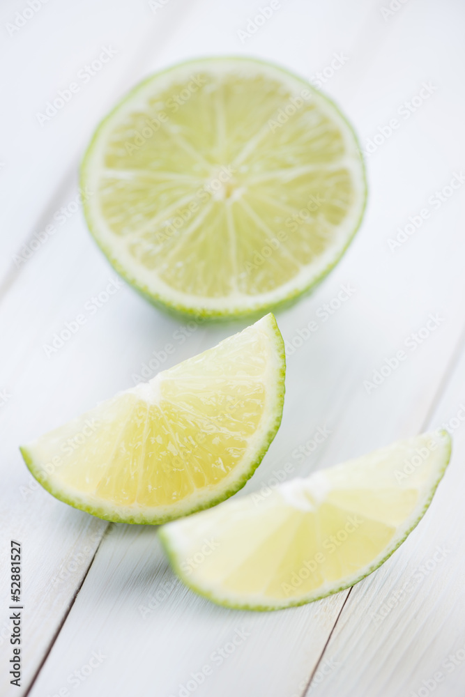 Sliced ripe lime on wooden boards, vertical shot Sliced ripe lime on wooden boards, vertical shot