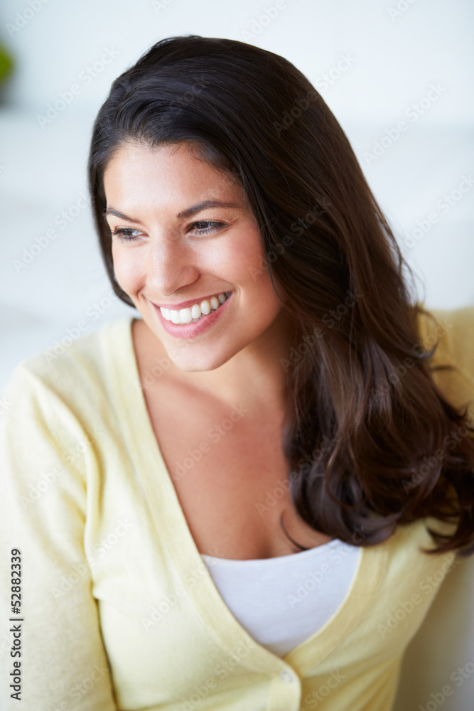 Smiling Woman Sitting On Sofa