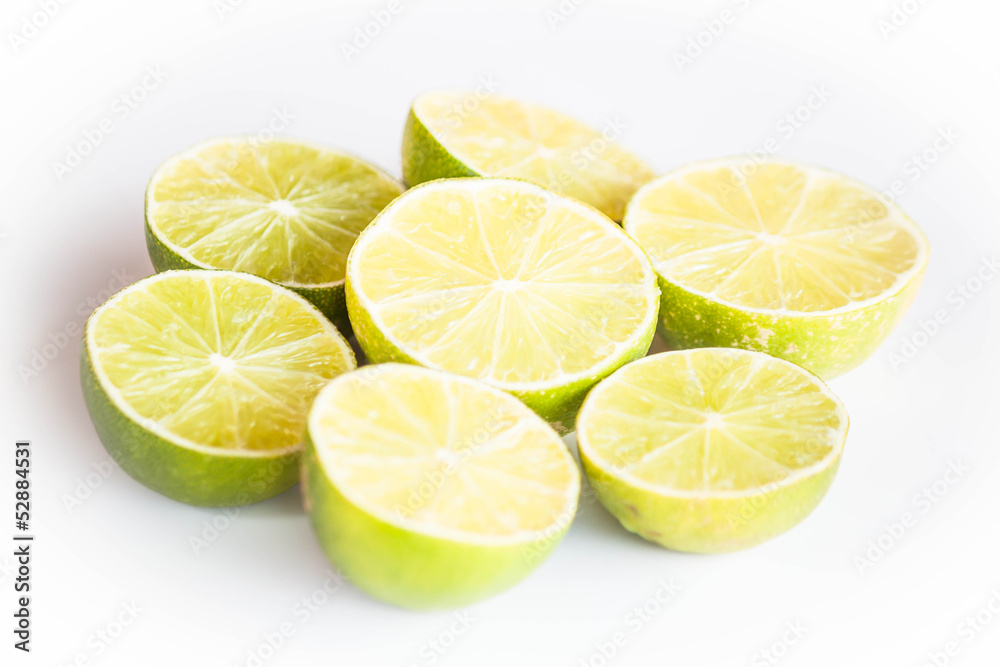 Fresh citrus lime half portion slice on white background Fresh citrus lime half portion slice on white background