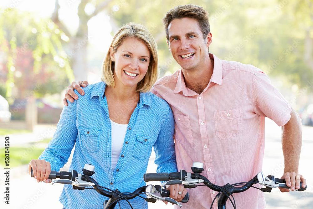 Obraz premium Couple Cycling On Suburban Street