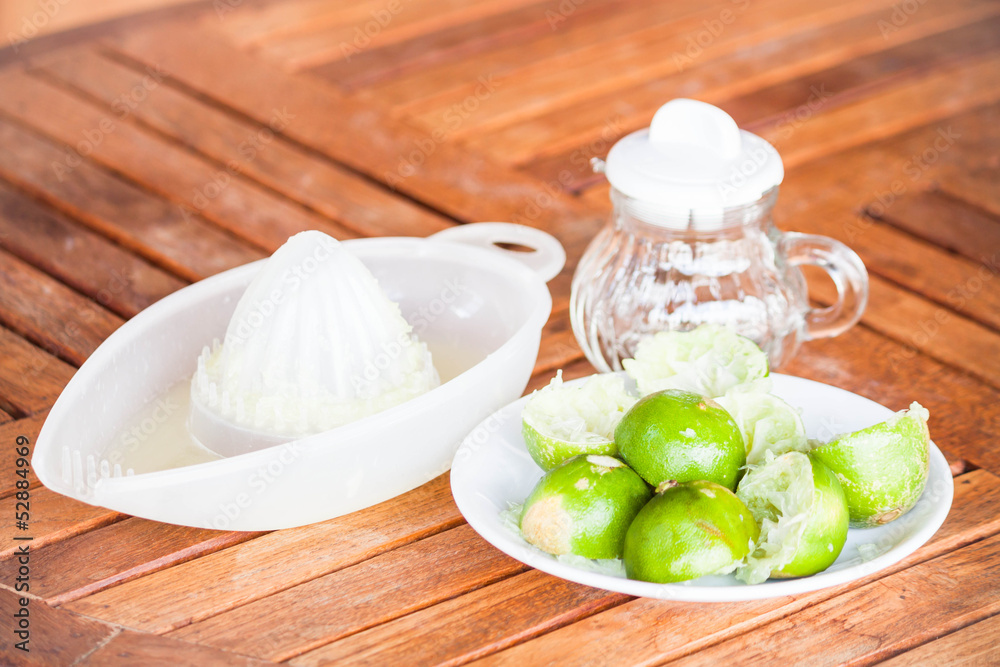 After squashed fresh lime on wood counter After squashed fresh lime on wood counter