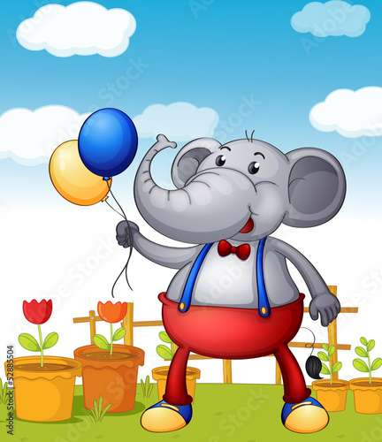 An elephant holding balloons with pots of flower at the back