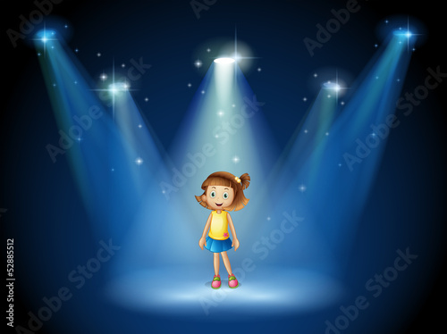 A girl smiling in the middle of the stage under the spotlights