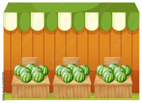 A shop of watermelons with empty boards