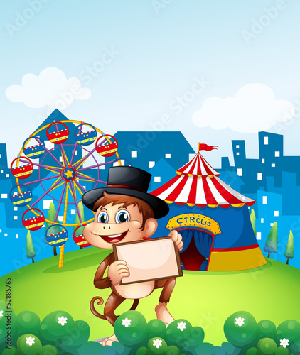 A monkey holding a frame in front of the carnival