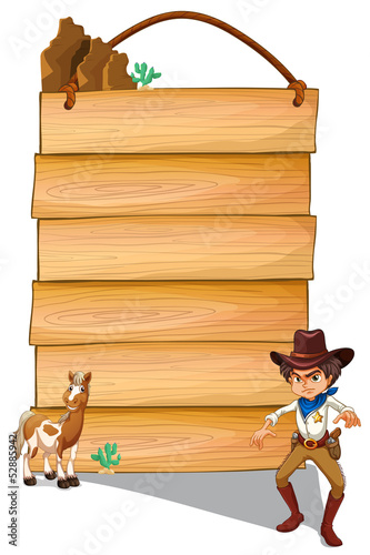 A cowboy and a donkey in front of the empty signboards