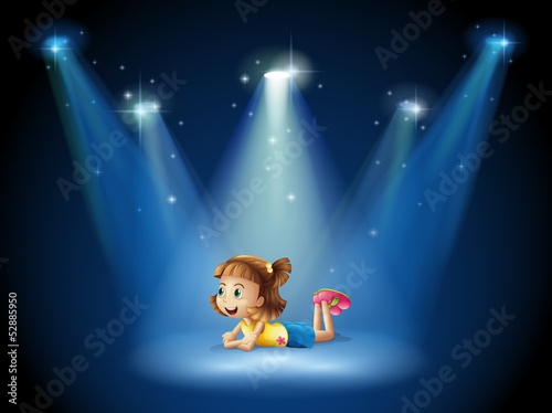 A cute little girl at the stage with spotlights