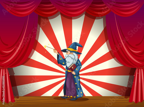 A wizard holding a wand in the middle of the stage
