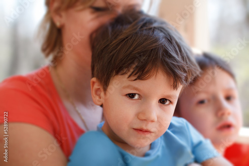 Little preschooler boy with mother and brother on train