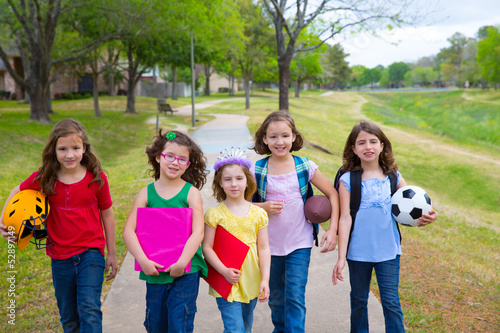 Children kid girls walking to schoool with sport balls