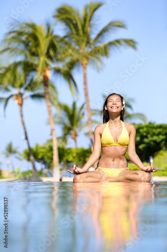 Serene meditating woman relaxing at luxury travel