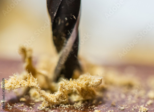 Brad point wood drill bit drilling a wood surface