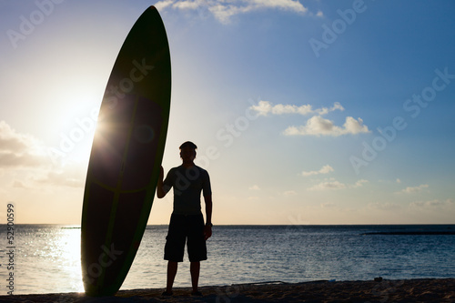Silhouette of a man with paddle board